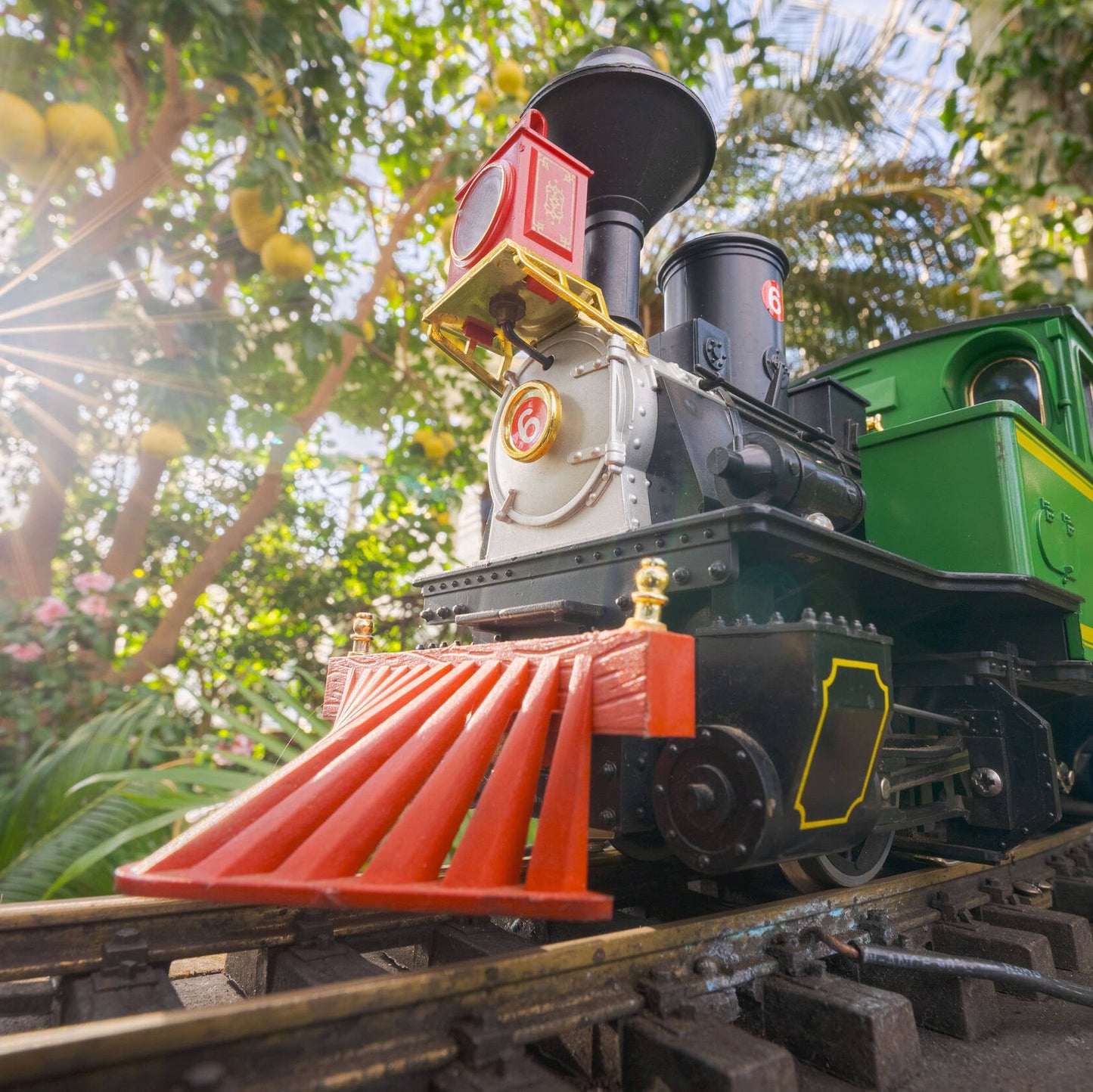 Toy train on a track with trees in the background